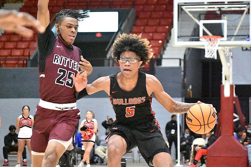 Jai'Chaunn Hayes of White Hall attacks the basket against Norman Martin of Cardinal Ritter in the second quarter Tuesday, Dec. 28, 2021. (Pine Bluff Commercial/I.C. Murrell)