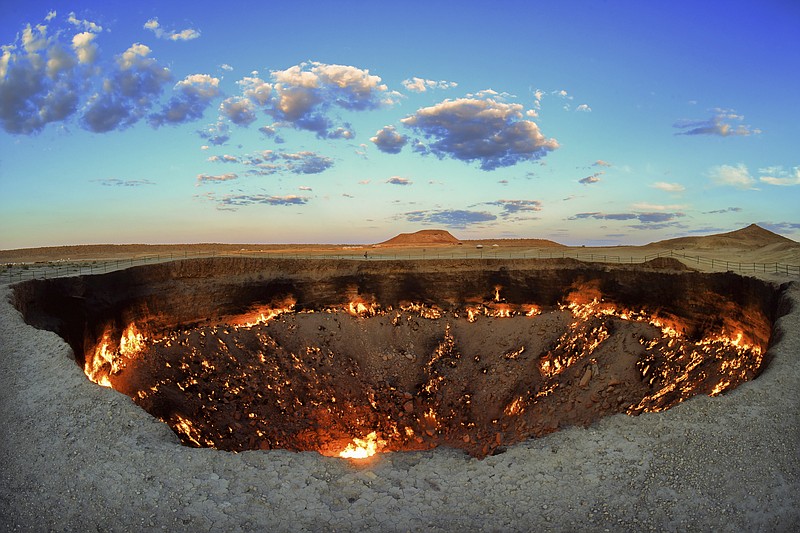 The crater fire named &quot;Gates of Hell&quot; is seen near Darvaza, Turkmenistan, Saturday, July 11, 2020. The president of Turkmenistan is calling for an end to one of the country's most notable but infernal sights &#x2014; the blazing desert natural gas crater widely referred to as the &#x201c;Gates of Hell.&#x201d; The crater, about 260 kilometers (160 miles) north of the capital Ashgabat, has been on fire for decades and is a popular sight for the small number of tourists who come to Turkmenistan, which is difficult to enter. (AP Photo/Alexander Vershinin)
