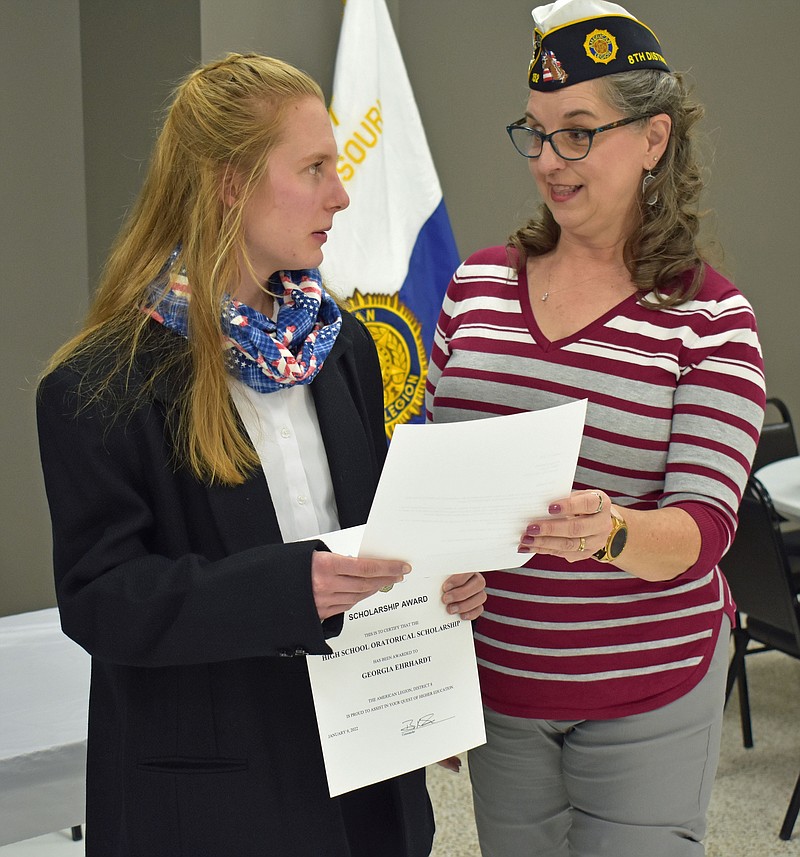 At left, Georgia Ehrhardt, 16, accepts first place and a $500 scholarship from Christine Sapp after competing in the 88th annual High School Oratorical Scholarship Program Sunday, Jan. 9, 2022. Next, she'll compete in one of four state zone competitons. Sapp is the chairwoman of the district competition. (Gerry Tritz/News Tribune photo)