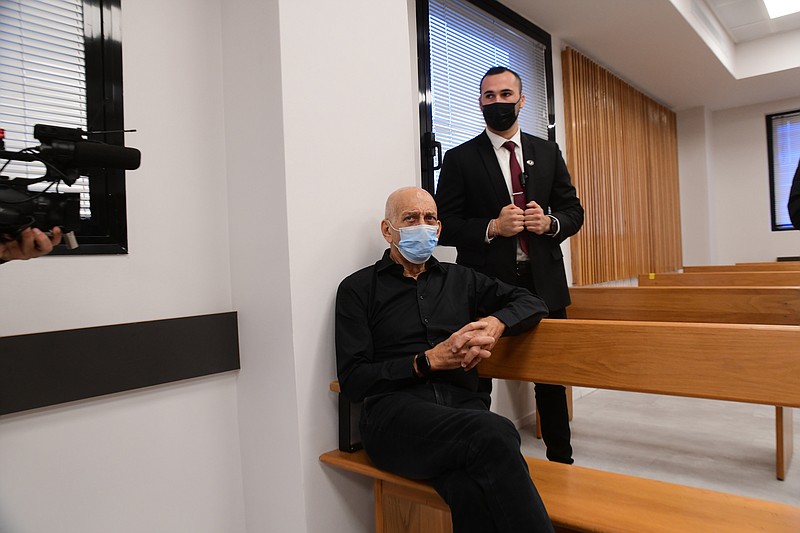 Former Israeli Prime Minister Ehud Olmert sits in the Tel Aviv Magistrate's Court Monday, Jan. 10, 2022, during a preliminary hearing in a defamation lawsuit. Former Prime Minister Benjamin Netanyahu, his wife and son appeared in the Tel Aviv Magistrate&#x2019;s court Monday for the opening of their case against Olmert, Netanyahu&#x2019;s predecessor as Israel&#x2019;s prime minister. The Netanyahus are suing Olmert for saying they suffered from &#x201c;mental illness&#x201d; during an interview last year. (Avshalom Sassoni/Pool Photo via AP)