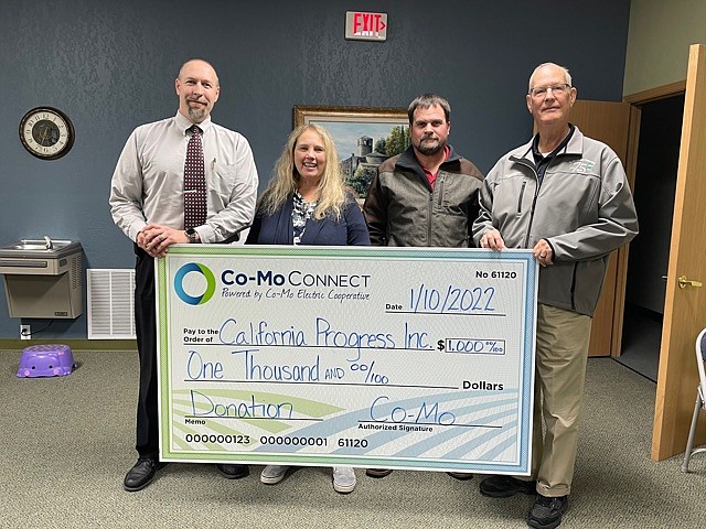 California Progress Inc. members Matt Abernathy and Susan Hodges accept a $1,000 donation from Co-Mo Connect for Latham Memorial Family Park's new playground addition. (Democrat photo/Kaden Quinn)