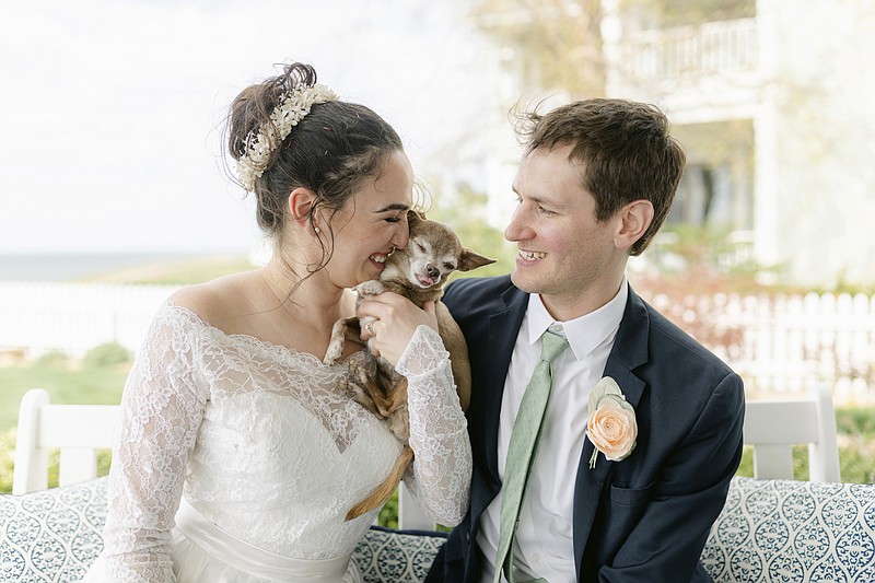 Caitlin Koska, left, and Michael White appear with their 14-year-old rescue dog, Luna, at their wedding on May 1, 2021, in St. Joseph, Mich. The couple adopted their pet after her owner died through Tyson&#x2019;s Place Animal Rescue, a specialized organization focused on helping the terminally ill and seniors headed to residential care. (Cat Carty Buswell via AP)