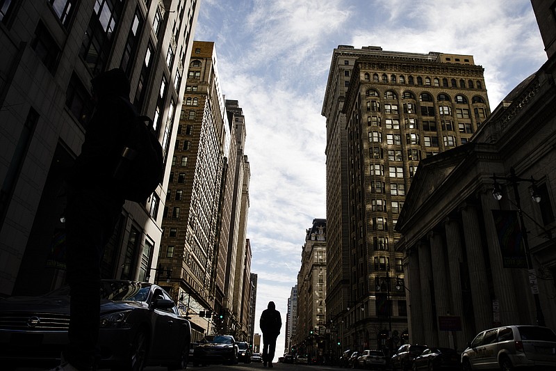 A pedestrian walks down South Broad Street in Philadelphia, Feb.  8, 2019. Building credit from scratch when you’re young can feel overwhelming; it’s no wonder that nearly 40% of Americans between the ages of 20 and 24 have no credit history or too insufficient of a credit history to have a score, according to the Consumer Finance and Protection Bureau. (AP Photo/Matt Rourke, File)