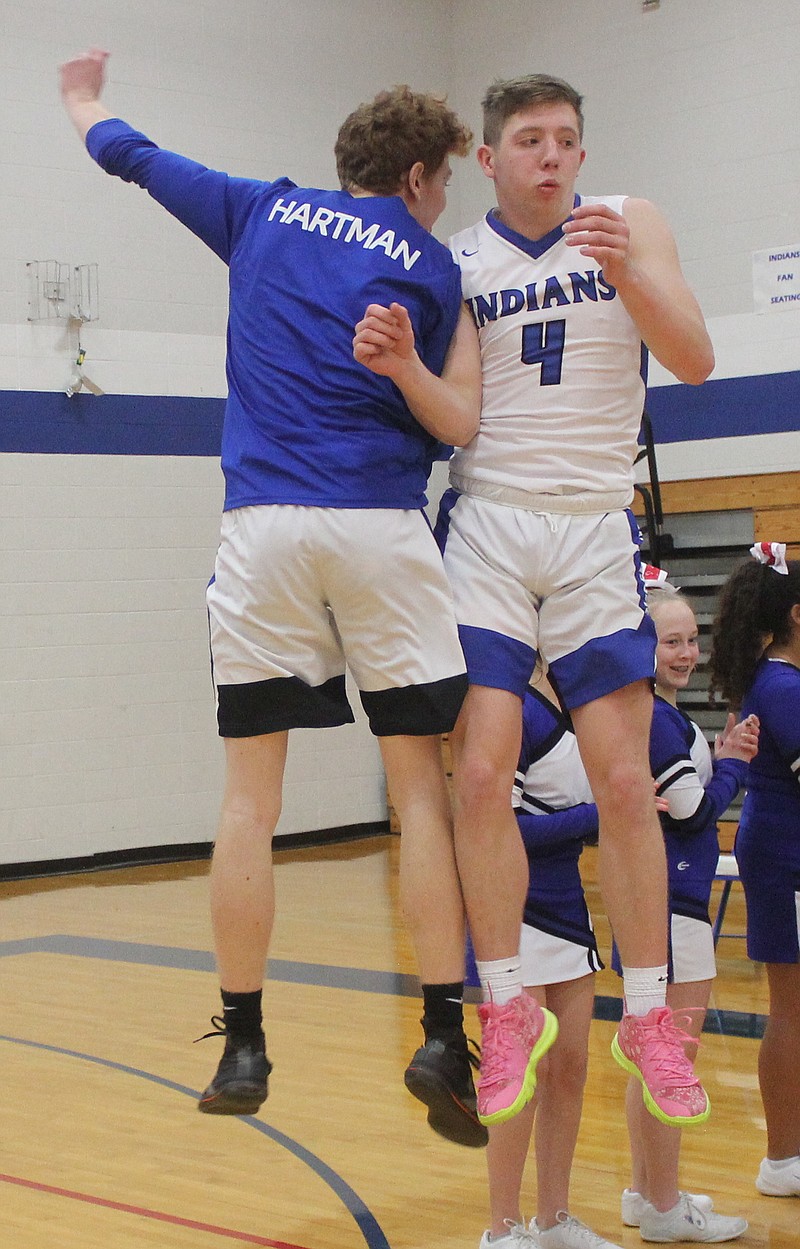 Russellville senior Simon Hartman and junior Alex Oligschlaeger share a celebratory bump after the latter is introduced into the Indians' starting lineup.