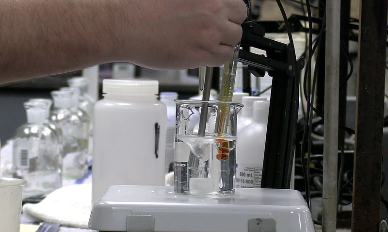 Effluent samples wait to be tested in January 2022 at the Davidson Drive regional wastewater treatment plant’s lab. - File photo by Donald Cross of The Sentinel-Record