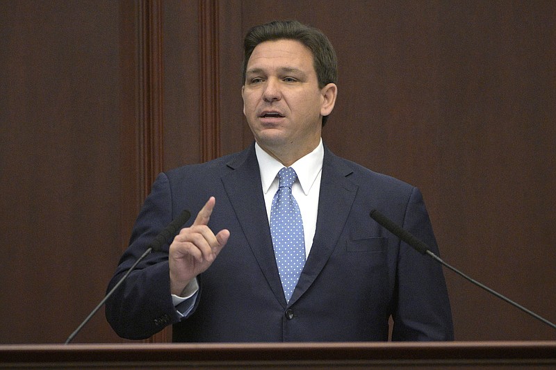 FILE - Florida Gov. Ron DeSantis addresses a joint session of a legislative session, Jan. 11, 2022, in Tallahassee, Fla. Trump is slamming politicians who refuse to say whether they&#x2019;ve received COVID-19 booster shots, calling them &#x201c;gutless.&#x201d; In an interview with One America News Network on Tuesday night, he said unnamed politicians have been afraid to admit they got the booster shot. Trump did not name names, but Florida Gov. Ron DeSantis, who is often mentioned as a possible 2024 presidential contender, has notably declined to say whether he has received a booster.  (AP Photo/Phelan M. Ebenhack, File)