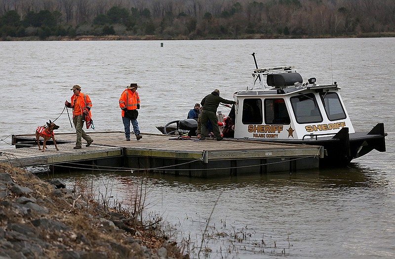 Search dogs are offloaded from a Pulaski County sheriff's office boat on Friday, Jan. 14, 2022, at Park on the River in Maumelle after searching for a missing Maumelle woman. (Arkansas Democrat-Gazette/Thomas Metthe)