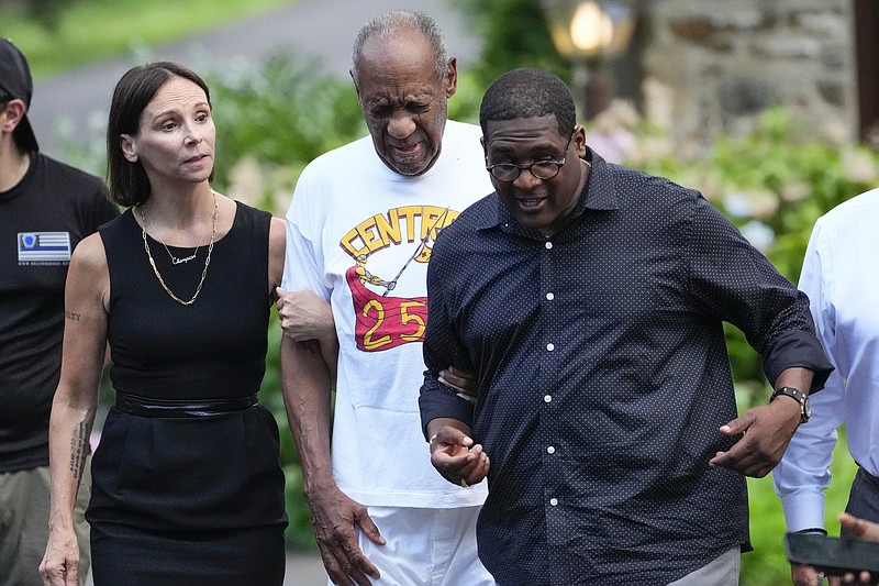 FILE - Bill Cosby, center, and spokesperson Andrew Wyatt, right, and attorney Jennifer Bonjean, left, approach members of the media gathered outside Cosby's home in Elkins Park, Pa., on June 30, 2021. An Illinois judge could be facing discipline after he mocked Bonjean in comments that he apparently did not realize were being broadcast live on YouTube. (AP Photo/Matt Slocum, File)