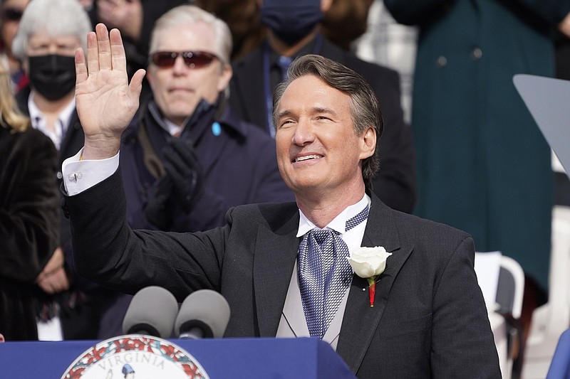 Virginia Gov. Glenn Youngkin waves to the inaugural crowd after being sworn in at the Capitol Saturday Jan. 15, 2022, in Richmond, Va. (AP Photo/Steve Helber)