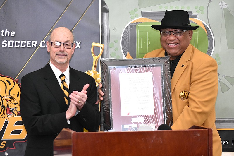 University of Arkansas System President Donald Bobbitt, left, presents a resolution honoring system Board Chairman Stephen Broughton, of Pine Bluff, during a groundbreaking ceremony for the UAPB soccer and track-and-field complex on Saturday, Jan. 15, 2022. (Pine Bluff Commercial/I.C. Murrell)
