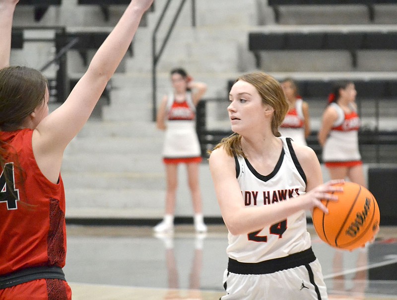Senior Lady Blackhawk Mikayla Humphrey, No. 24, looks for a receiver to whom to pass the ball while guarded by a Farmington player Tuesday, Jan. 11, in Blackhawk Arena.