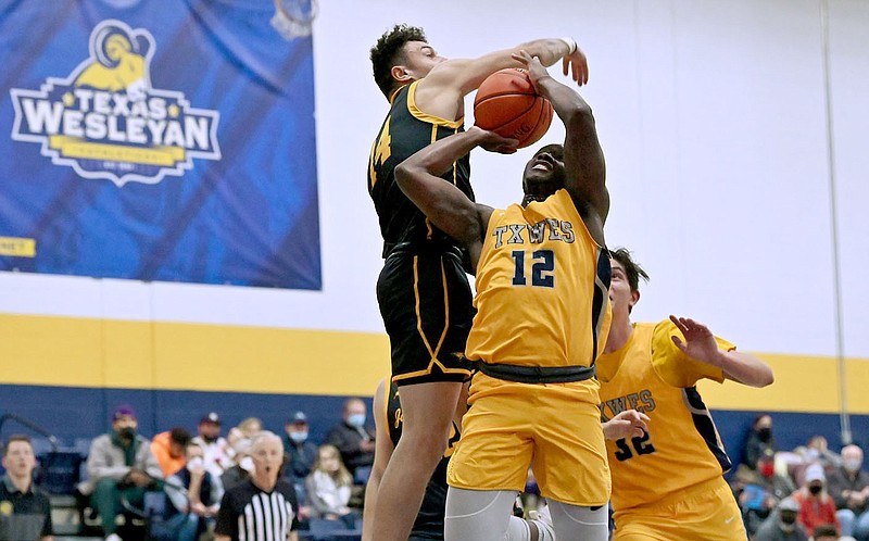 Photo courtesy of Texas Wesleyan
John Brown's James Beckom (left) goes up against Davon Berry during Saturday's game in Fort Worth, Texas.