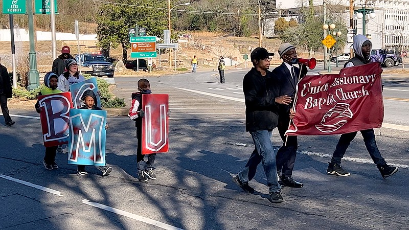 Members of Union Missionary Baptist Church in Hot Springs walk near the front of Monday's MLK Jr. Parade as they come onto Whittington Ave. Photo by Brandon Smith/The Sentinel Record