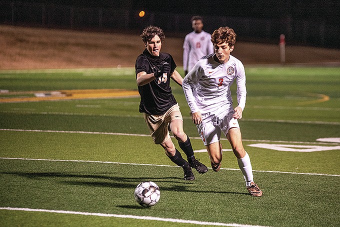 Pleasant Grove's Colten McEvoy and Texas High's Micheal Bradshaw compete for the ball during a soccer match in January 2020 at Hawk Stadium. The cross-town rivals meet again Tuesday, Jan. 18, 2022, at Texas High's Grim Stadium in Texarkana. (Gazette file photo)