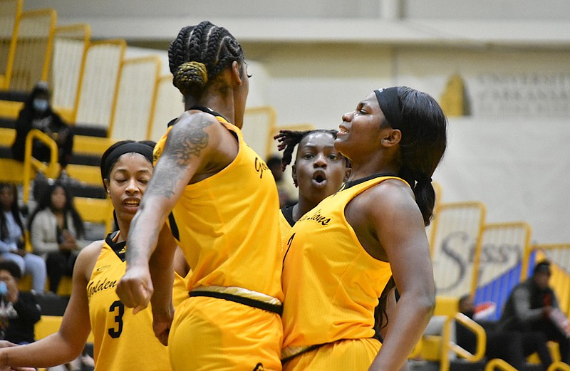 Zaay Green, left, and Sade Hudson celebrate a made basket as Green was fouled by Bethune-Cookman in the first half Monday, Jan. 17, 2022, at H.O. Clemmons Arena. Also in on the reaction are Joyce Kennerson, left in background, and Takaylyn Busby. (Pine Bluff Commercial/I.C. Murrell)