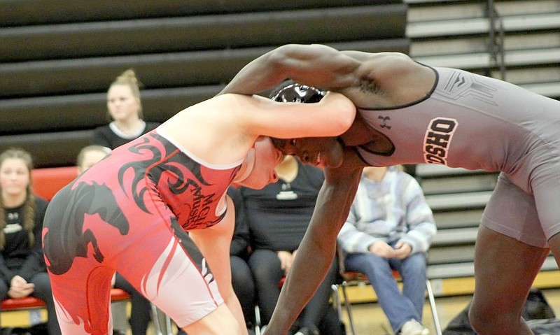 KAYLNN PHILLIPS/SPECIAL TO MCDONALD COUNTY PRESS
McDonald County wrestler John Clemons (left) competes against Neosho's Talon Mitchell during a match Jan. 13 in Anderson.