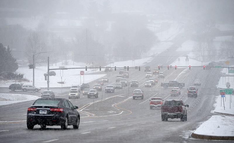 FILE — Traffic moves on College Avenue Saturday, Jan. 15, 2022,  near Joyce Boulevard as snow falls in Fayetteville. Visit nwaonline.com/220116Daily/ for the day's photo gallery. (NWA Democrat-Gazette/Andy Shupe)