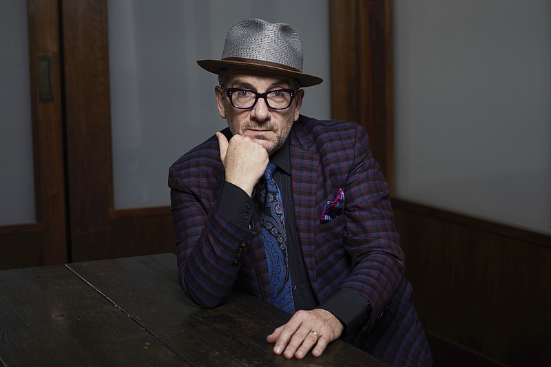 Elvis Costello poses for a portrait in New York in 2018. Costello’s new album, the coronavirus-era disc “The Boy Named If” was made in solitary style — four musicians, five if you count a backup singer on one song, all worked from their own homes. He says that conjures the image of a laid-back sound, but the new disc is an up-tempo, guitar-based selection of crankin’ rock songs. (Invision/AP file/Matt Licari)