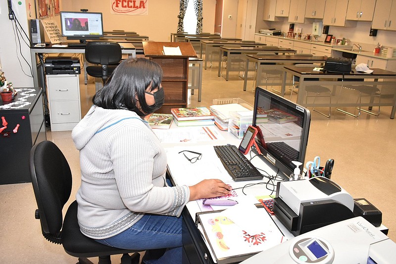 Dollarway High School Family and Consumer Sciences instructor Bethel Byrd works in an empty classroom Tuesday, Jan. 18, 2022. Pine Bluff School District students were kept at home as staff members developed a plan to minimize student transitions and increase teacher coverage to supervise and instruct students upon their return today. (Pine Bluff Commercial/I.C. Murrell)