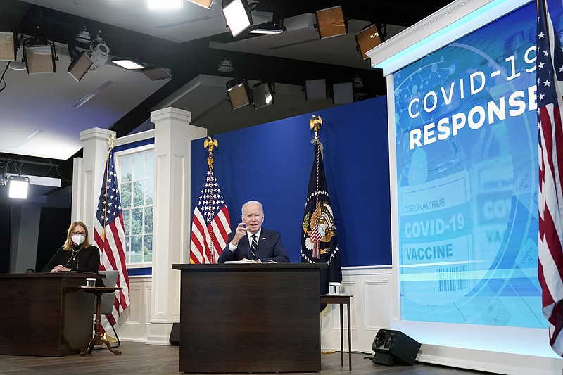 President Joe Biden, accompanied by FEMA administrator Deanne Criswell, speaks about the government's COVID-19 response, in the South Court Auditorium in the Eisenhower Executive Office Building on the White House Campus in Washington, Thursday, Jan. 13, 2022. (AP Photo/Andrew Harnik)