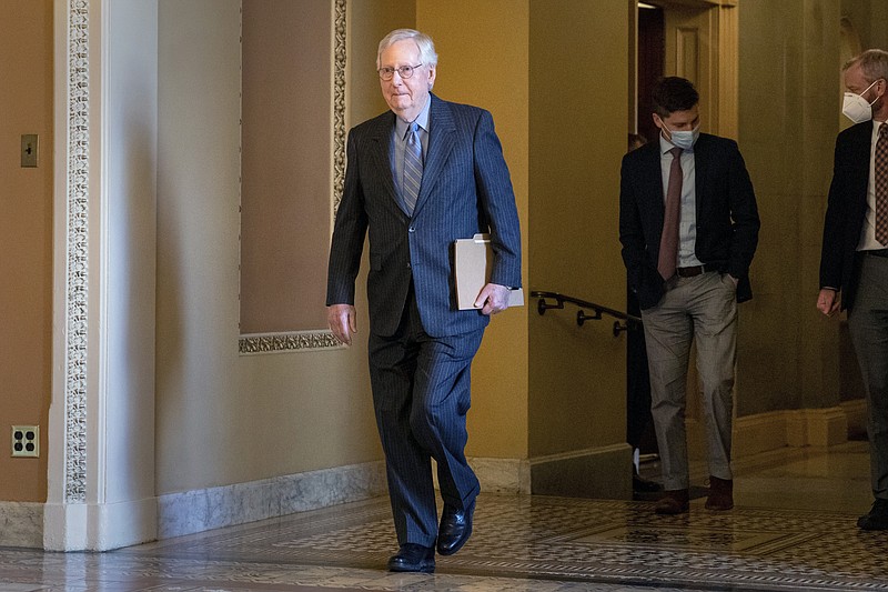 Senate Minority Leader Mitch McConnell, R-Ky., walks through the halls of the Capitol in Washington, Tuesday, Jan. 18, 2022. (AP Photo/Amanda Andrade-Rhoades)