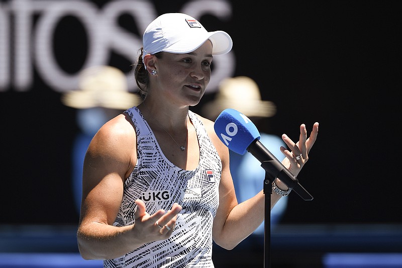 Ash Barty of Australia reacts as she is interviewed after defeating Lucia Bronzetti of Italy in their second round match at the Australian Open tennis championships in Melbourne, Australia, Wednesday, Jan. 19, 2022. (AP Photo/Andy Brownbill)