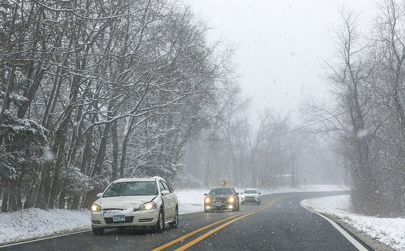 FILE — Cars drive along a snowy landscape, Saturday, January 15, 2022 along US Highway 62 outside of Gateway. Check out nwaonline.com/220116Daily/ for the day's photo gallery. 
(NWA Democrat-Gazette/Charlie Kaijo)