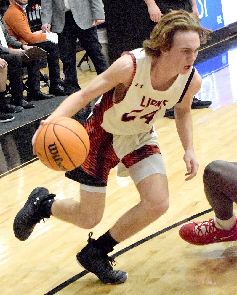 Westside Eagle Observer/MIKE ECKELS
As a Cardinal defender falls to the court, Gunnar Woolard makes his run on the basket from the right wing during the Jan. 18 Gravette-Farmington varsity boys basketball contest at the Lions' Den in Gravette. Woolard made the layup for two of his 17 points. Farmington took the conference win 49-44 over Gravette.