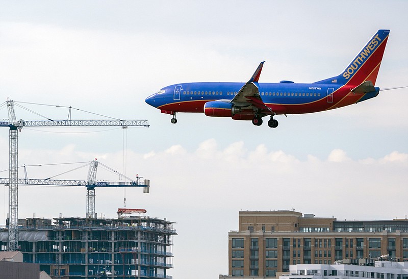 A Southwest passenger flight lands at Reagan Washington National Airport in Arlington, Va., across the Potomac River from Washington, Wed., Jan. 19, 2022. The airline industry is raising the stakes in a showdown with AT&amp;T and Verizon over plans to launch new 5G wireless service this week, warning that thousands of flights could be grounded or delayed if the rollout takes place near major airports. (AP Photo/J. Scott Applewhite)