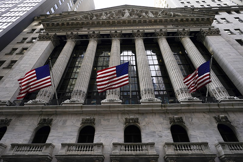 American flags fly outside the New York Stock exchange, Friday, Jan. 14, 2022, in the Financial District.  Stocks rose in morning trading on Wall Street Wednesday, Jan. 19, and chipped away at some of their losses from a tumble a day earlier.(AP Photo/Mary Altaffer)