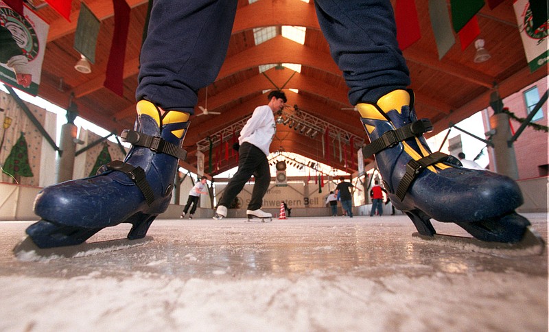 A skater slides slowly off the ice Dec. 12, 1998, as others enjoy laps around the Little Rock River Market's Miracle at the Market ice skating rink. (Democrat-Gazette file photo)