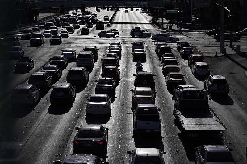 FILE - In this April 22, 2021 file photo, cars wait at a red light during rush hour at the Las Vegas Strip, in Las Vegas. Two organizations that influence many Americans? automobile buying decisions will begin rating vehicles on how well they track behavior of motorists who use partially automated driver-assist systems. Consumer Reports and the Insurance Institute for Highway Safety say the ratings will factor into scores for new models starting this year. The new ratings, announced Thursday, Jan. 20, 2022 come as the auto industry struggles with how to make sure drivers stay alert as the systems take on more driving functions. (AP Photo/John Locher, File)