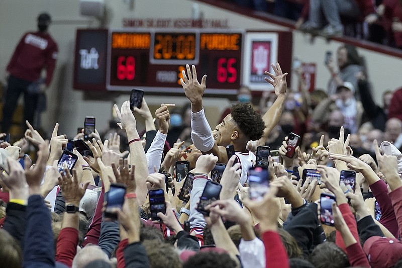 Indiana's Rob Phinisee, center right, celebrates with fans after the team defeated Purdue in an NCAA basketball game Thursday in Bloomington, Ind. – Photo by Darron Cummings of The Associated Press
