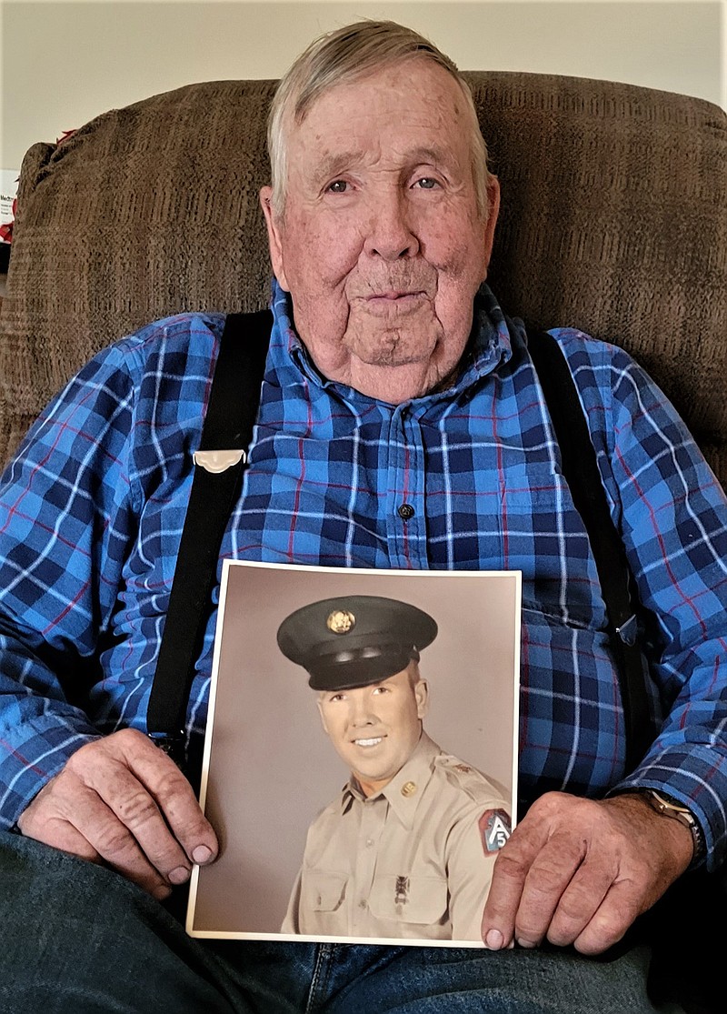 Bob Duncan holds a photo of him taken as a U.S. Army soldier. He enlisted in early 1958, months after graduating from Eugene High School. (Submitted photo)