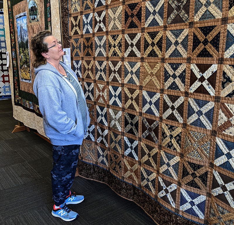 Westside Eagle Observer/RANDY MOLL
Diana Summers viewed a quilt at the Gentry Quilt Show held in the McKee Community Room at the Gentry Public Library last week. The annual show was again sponsored by McKee Foods.