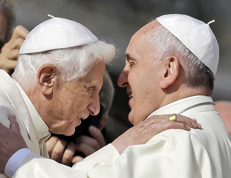 FILE - Pope Francis, right, hugs Pope Emeritus Benedict XVI prior to the start of a meeting with elderly faithful in St. Peter's Square at the Vatican, Sunday, Sept. 28, 2014. A long-awaited report on sexual abuse in Germany&#x2019;s Munich diocese on Thursday faulted retired Pope Benedict XVI&#x2019;s handling of four cases when he was archbishop in the 1970s and 1980s. (AP Photo/Gregorio Borgia, File)