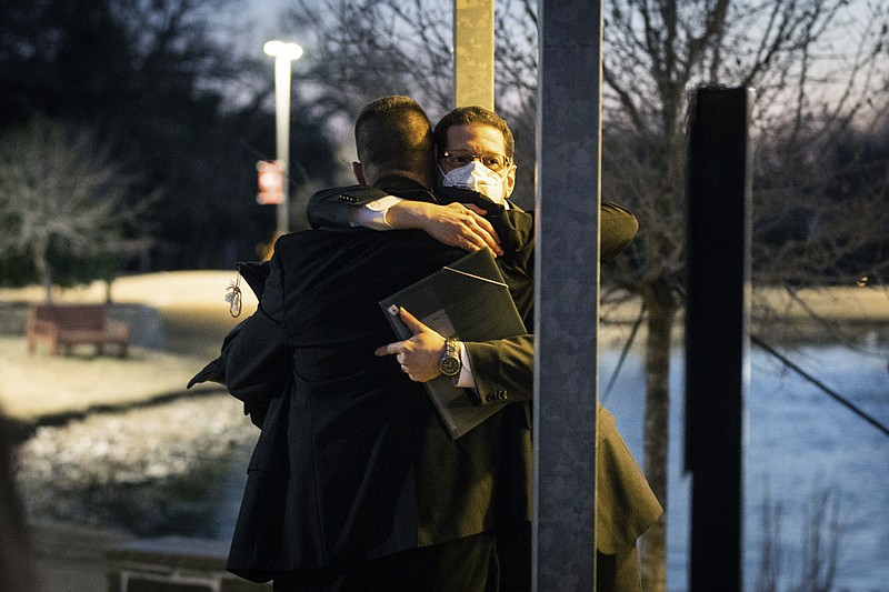 Congregation Beth Israel Rabbi Charlie Cytron-Walker, facing camera, hugs a man after a healing service Monday night, Jan. 17, 2022, at White&#x2019;s Chapel United Methodist Church in Southlake, Texas. Cytron-Walker was one of four people held hostage by a gunman at his Colleyville, Texas, synagogue on Saturday. (Yffy Yossifor/Star-Telegram via AP)