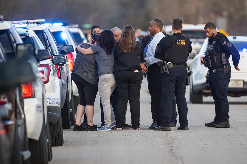 Sheriff's deputies investigate the scene where the bodies of three teenagers were found dead inside of a home, Tuesday, Jan. 18, 2022, in Crosby, Texas, about 25 miles northeast of Houston. (Brett Coomer/Houston Chronicle via AP)
