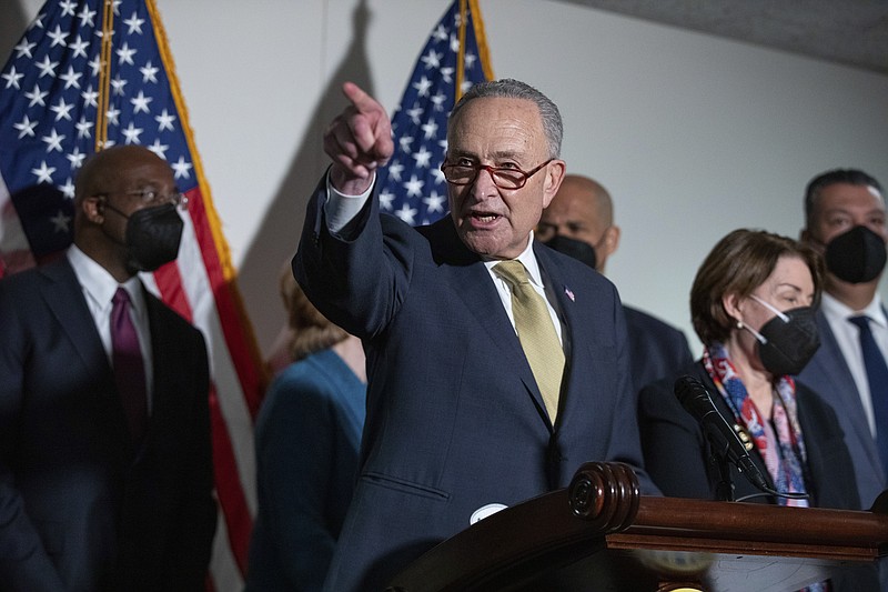 Senate Majority Leader Chuck Schumer, D-N.Y., speaks to reporters alongside, from left, Sen. Raphael Warnock, D-Ga., Sen. Cory Booker, D-N.J., Sen. Amy Klobuchar, D-Minn., and Sen. Alex Padilla, D-Calif., during a press conference regarding the Democratic party's shift to focus on voting rights at the Capitol in Washington, Tuesday, Jan. 18, 2022. (AP Photo/Amanda Andrade-Rhoades)