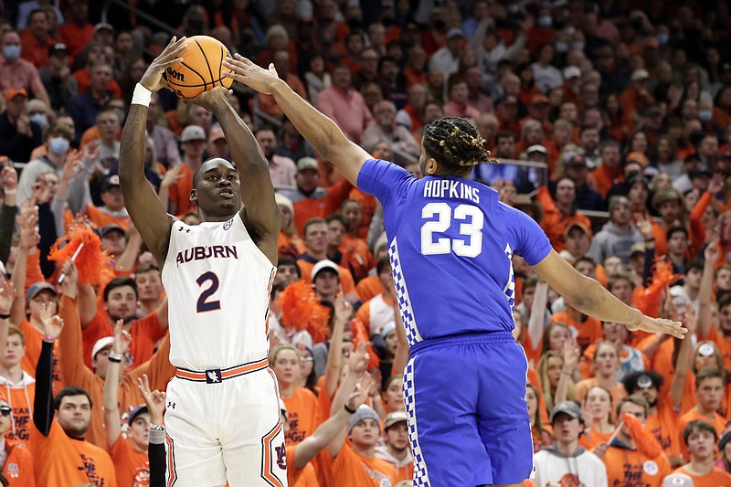 Auburn forward Jaylin Williams (2) shoots a three pointer as Kentucky forward Bryce Hopkins (23) defends during the second half of an NCAA college basketball game Saturday, Jan. 22, 2022, in Auburn, Ala. (AP Photo/Butch Dill)