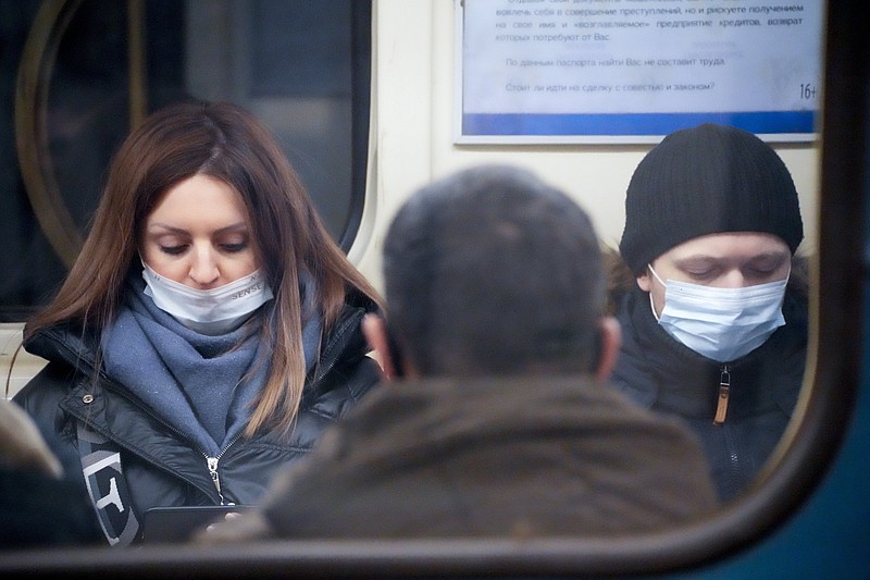People wearing face masks to help protect against the spread of the coronavirus ride a a subway car in an underground in St. Petersburg, Russia, Friday, Jan. 21, 2022. Daily new coronavirus infections in Russia have reached an all-time high and authorities are blaming the highly contagious omicron variant, which they expect to soon dominate the country's outbreak. Record numbers of new cases were reported &#xa0;in Moscow and in St. Petersburg, where health officials on Friday limited elective outpatient care.(AP Photo/Dmitri Lovetsky)