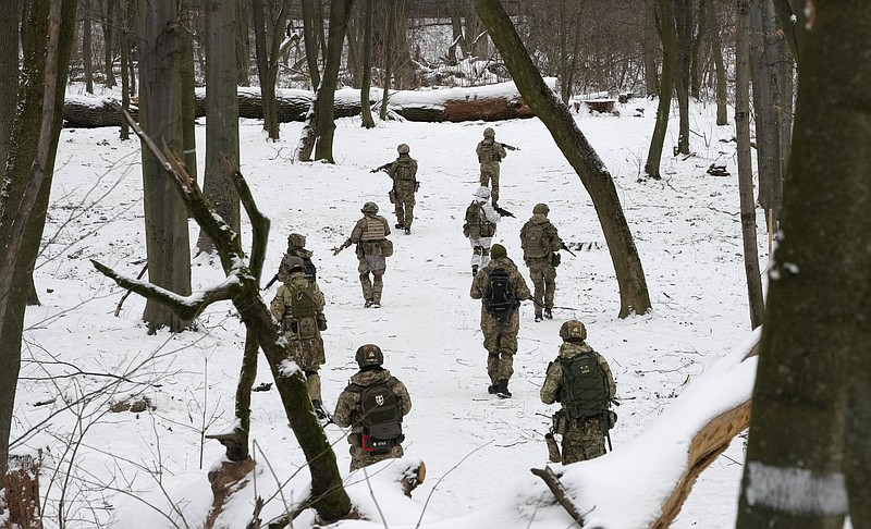 Members of Ukraine's Territorial Defense Forces, volunteer military units of the Armed Forces, train in a city park in Kyiv, Ukraine, Saturday, Jan. 22, 2022. Dozens of civilians have been joining Ukraine's army reserves in recent weeks amid fears about Russian invasion. (AP Photo/Efrem Lukatsky)