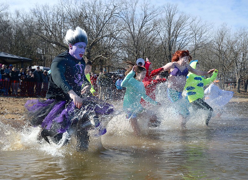 Representatives of Fulbright Junior High School in Bentonville run into the water Saturday, Feb. 8, 2020, dressed as characters from the movie, &quot;The Little Mermaid,&quot; during the 21st annual Beaver Lake Polar Plunge at Prairie Creek Swimming Area in Rogers. Teams and individuals dove into the 42-degree water to support Special Olympics Arkansas. Visit  nwaonline.com/200209Daily/ for today's photo gallery.
(NWA Democrat-Gazette/Andy Shupe)
