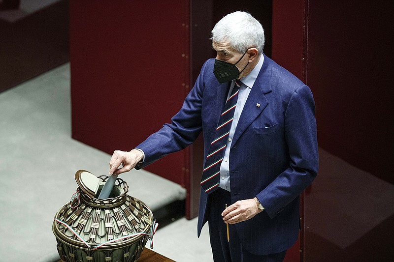 Lawmaker Pier Ferdinando Casini casts his ballot during the first round of votes in the Italian parliament, Monday, Jan. 24, 2022. The first round of voting for Italy&#x2019;s next president opens Monday without a clear slate of candidates following three-time ex-Premier Silvio Berlusconi&#x2019;s reluctant withdrawal. The situation that is likely to persist until Thursday. Italy&#x2019;s lawmakers and special regional representatives are set to vote for a successor to Sergio Mattarella as Italy&#x2019;s head of state. ( Roberto Monaldo/LaPresse via AP)