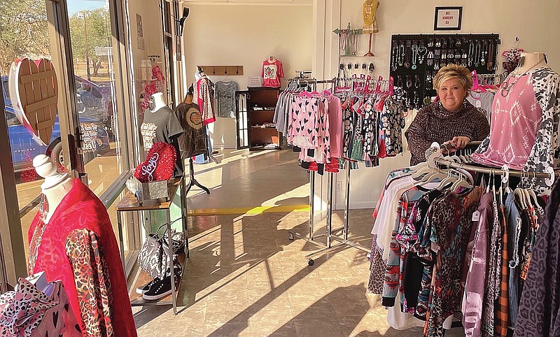 That’s Luci herself at right waiting to receive customers who will be considered more like family at her store, Luci’s Boutique on West Hiram in Atlanta. The store gives a spacious and welcoming impression from the customer’s very entry. (Staff photo by Neil Abeles)