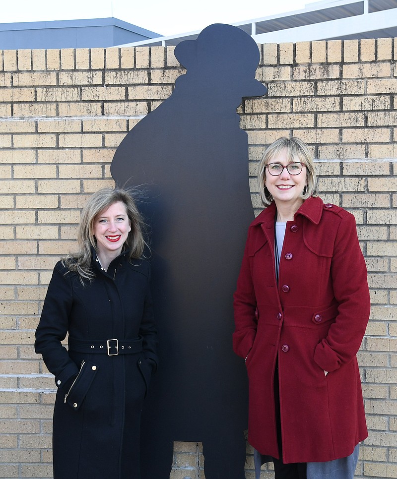 Michelle Roberts, committee chair for the Arkansas Cherry Blossom Festival, left, and Mary Zunick, executive director of the Hot Springs Sister City Foundation, stand in front of the monument of Kenji Miyazawa at the Hot Springs Convention Center, which will host the festival for the second year in a row. - Photo by Tanner Newton of The Sentinel-Record