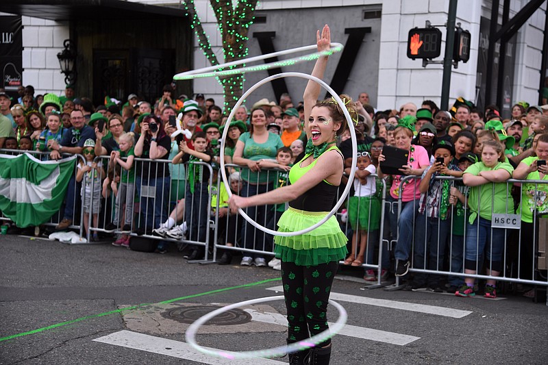 Hula Hooper Katie Sunshine warms up the crowd prior to the start of the First Ever 15th Annual World's Shortest St. Patrick's Day Parade in 2018 on Bridge Street. - File photo by The Sentinel-Record