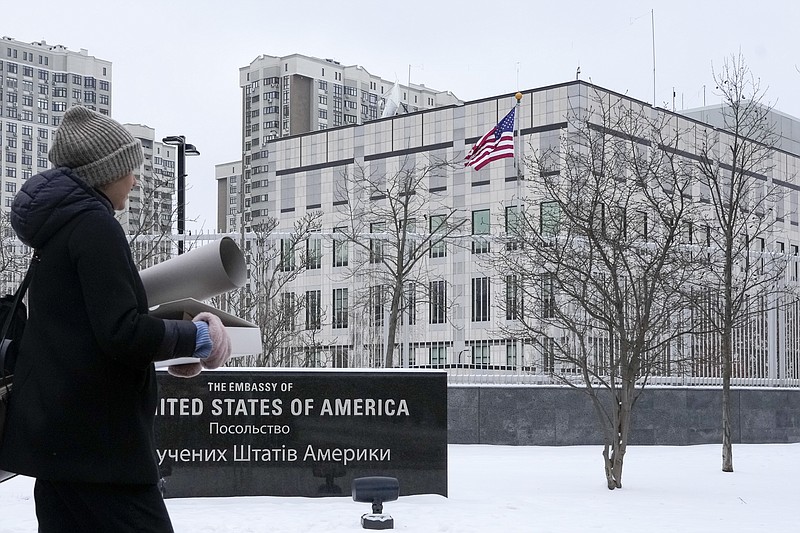 A woman walks past the U.S. Embassy in Kyiv, Ukraine, Monday, Jan. 24, 2022. The State Department is ordering the families of all American personnel at the U.S. Embassy in Kyiv to leave the country and allowing non-essential staff to leave Ukraine. The move comes amid heightened fears of a Russian invasion of Ukraine despite talks between U.S. and Russian officials. (AP Photo/Efrem Lukatsky)