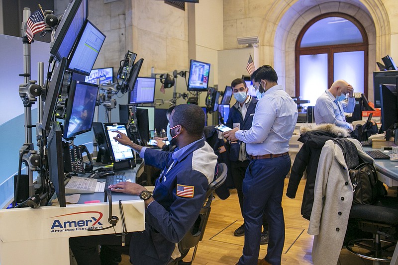 Traders work on the New York Stock Exchange floor in New York on Tuesday, Jan. 25, 2022. Stocks are closing lower on Wall Street Tuesday after another volatile day of trading. Technology companies like Microsoft were again the biggest drag on the market. (AP Photo/Ted Shaffrey)