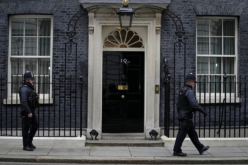 Police officers walk past 10 Downing Street in London, Tuesday, Jan. 25, 2022. London police say they are now investigating Downing Street parties during lockdown. Metropolitan Police Commissioner Cressida Dick revealed an investigation was underway in a statement before the London Assembly on Tuesday. Dick said Scotland Yard is now investigating &quot;a number of events&quot; at Downing Street. (AP Photo/Kirsty Wigglesworth)